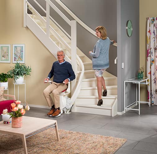 Otolift Stairlifts man and woman at bottom of stairs - Breffni Mobility | The Stairlift Specialists